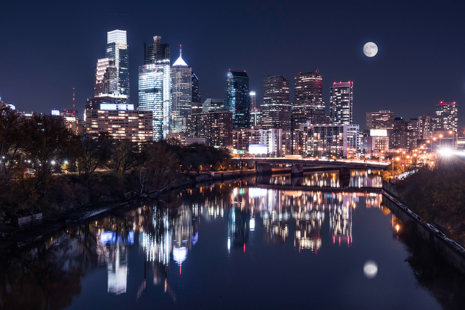 city skylines at night with moon