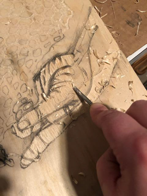 Carving the artwork by hand.