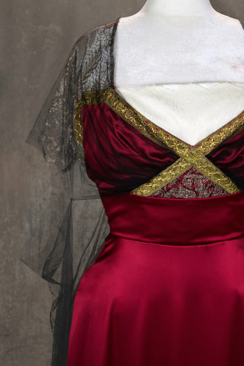 A 1911-inspired gown for an elegant bride. The gown is sewn in duchesse silk satin with antique repurposed trims and laces. The interior is finished by hand with boning for silhouette support.