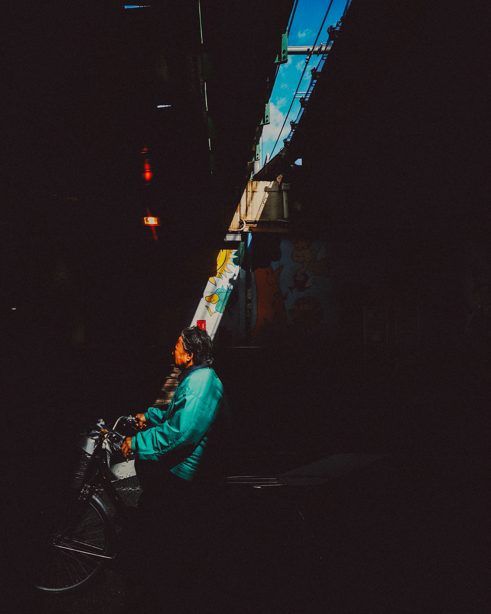 A biker in a shadowy underpass, Shinjuku, Tokyo, Japan, October 2019, Huawei P30 Pro.