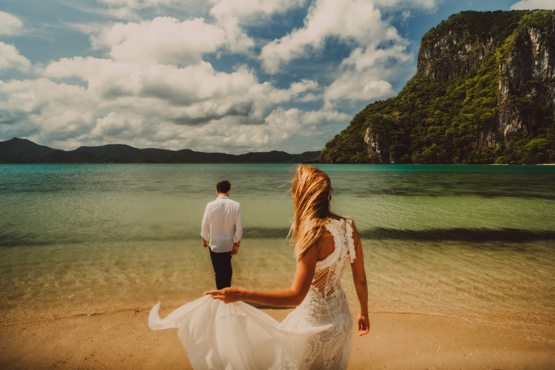 A honeymoon couple shoot in Lagen Island's sandbar on a bright and sunny morning, El Nido, Palawan, Philippines, Southeast Asia, December 2019, Sony A7III.