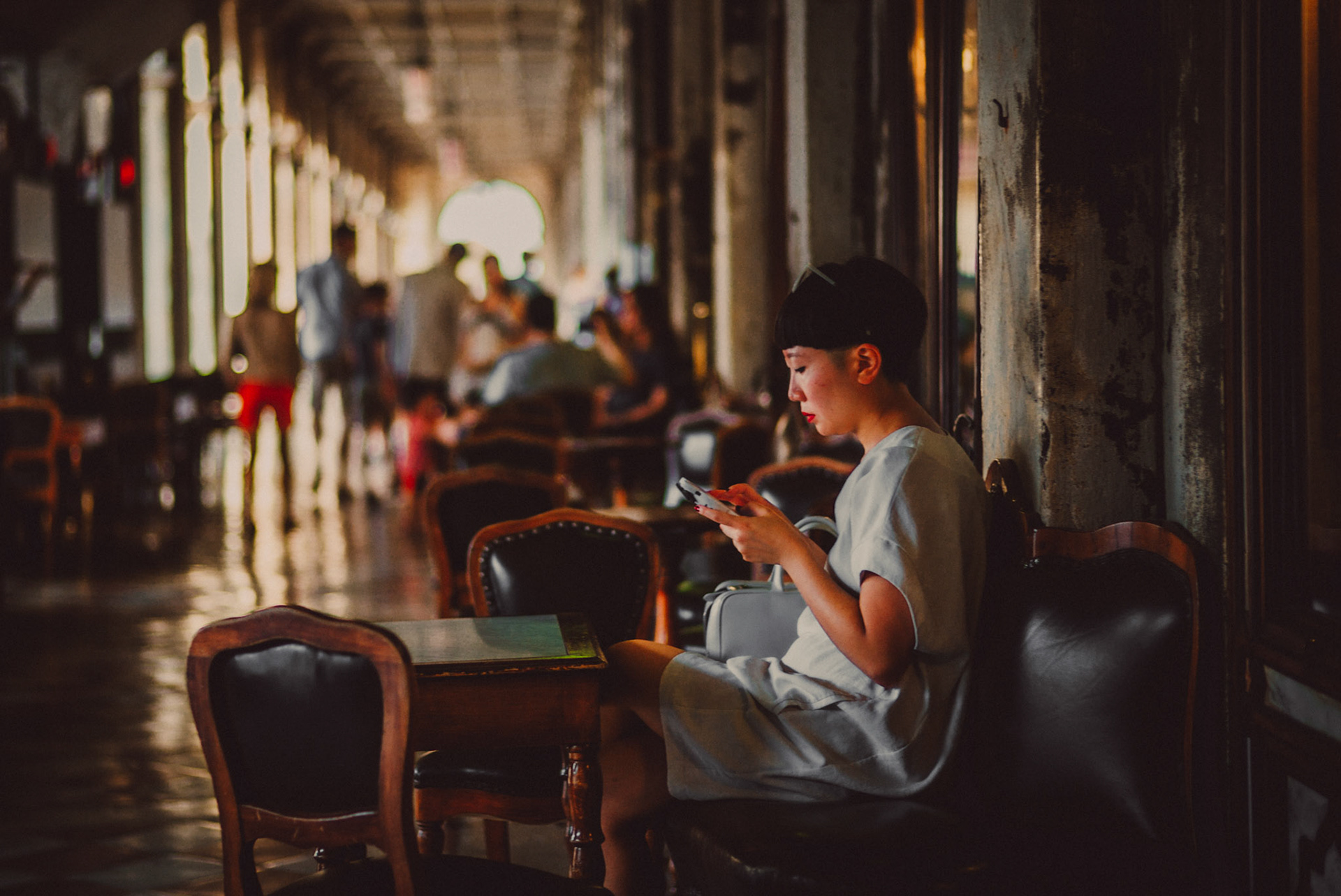 A trendy Asian woman in a cafe at St Mark's Square, Venice, Italy, August 2017, Leica M.