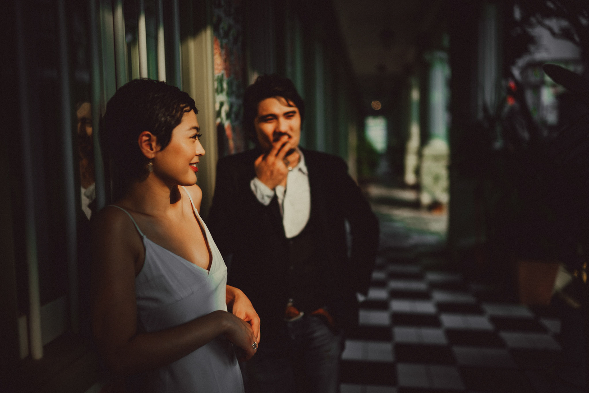 A Japanese couple sharing a lighthearted moment in a sunlit corridor with Peranakan details, from Ibuki and Emi's artsy moody engagement shoot, Pertain Road, Little India, Singapore, October 2015, Sony A7S.