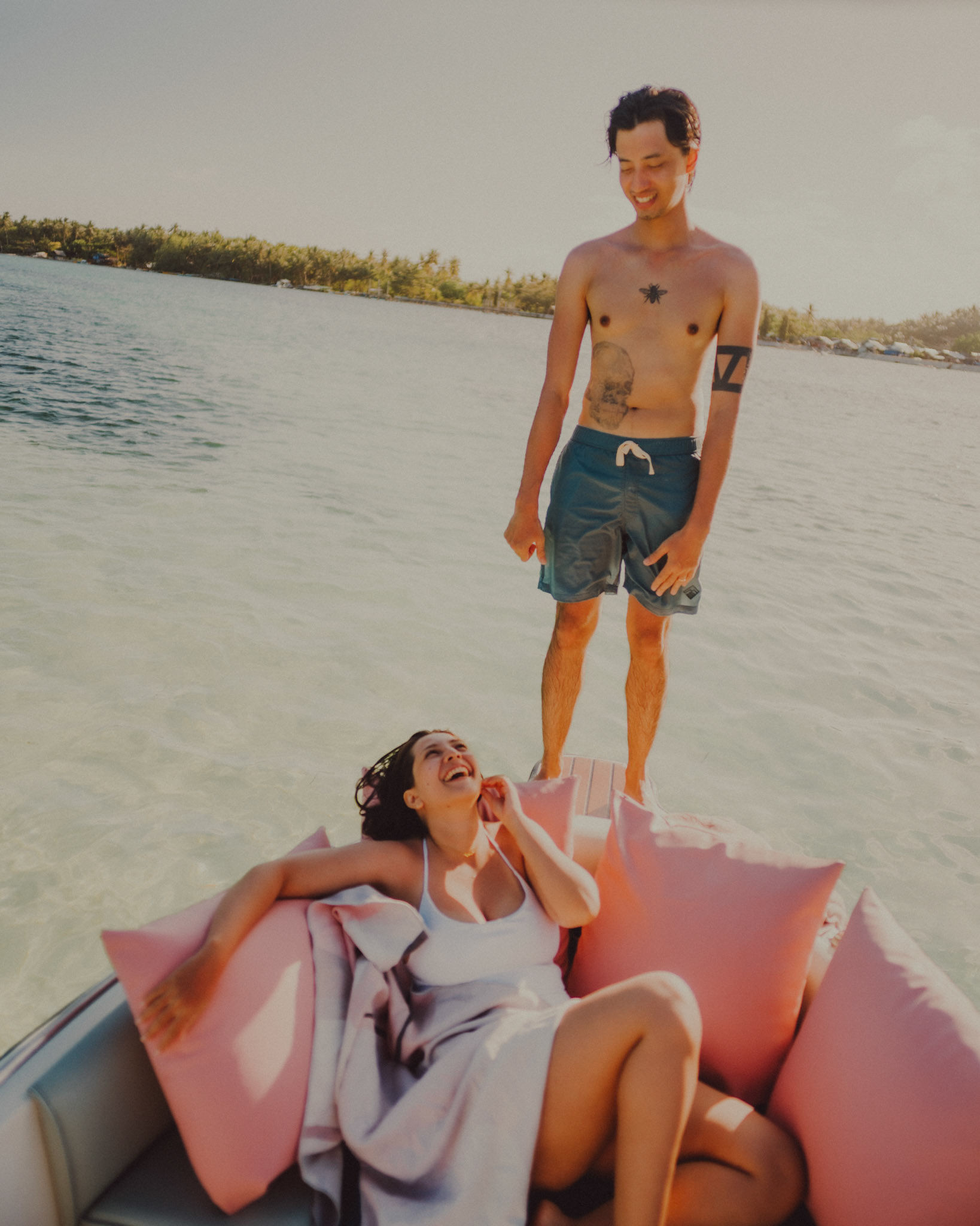 Chill adventure portraits on the edge of a speedboat, from Jeo and Bianca's island hopping honeymoon couple portrait shoot in Siargao Island, Philippines, Southeast Asia, February 2020, Sony A7III