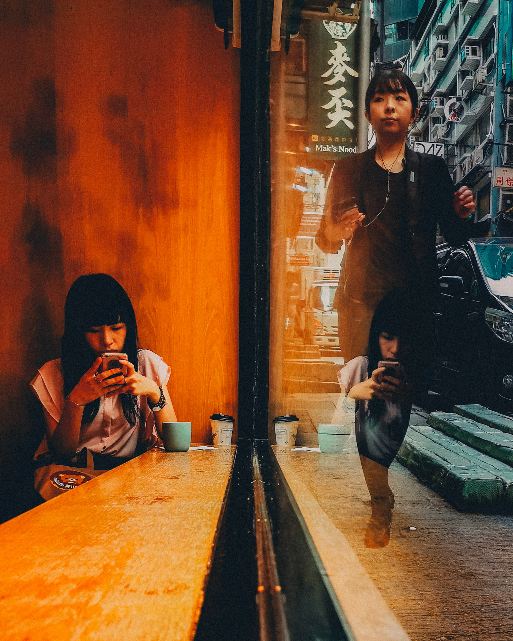 A pedestrian and a girl on a coffee shop window, The Cupping Room, Central, Hong Kong, July 2019, Huawei P30 Pro.
