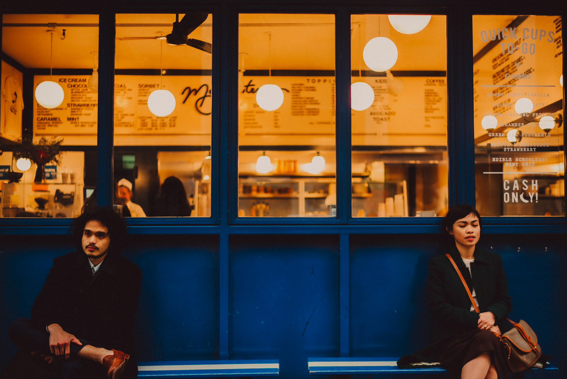 Moody couple portraits outside Morgenstern's Finest Ice Cream, from AC &amp; Winona's casual and chill engagement shoot in Manhattan, New York City, USA, December 2017, Leica M.