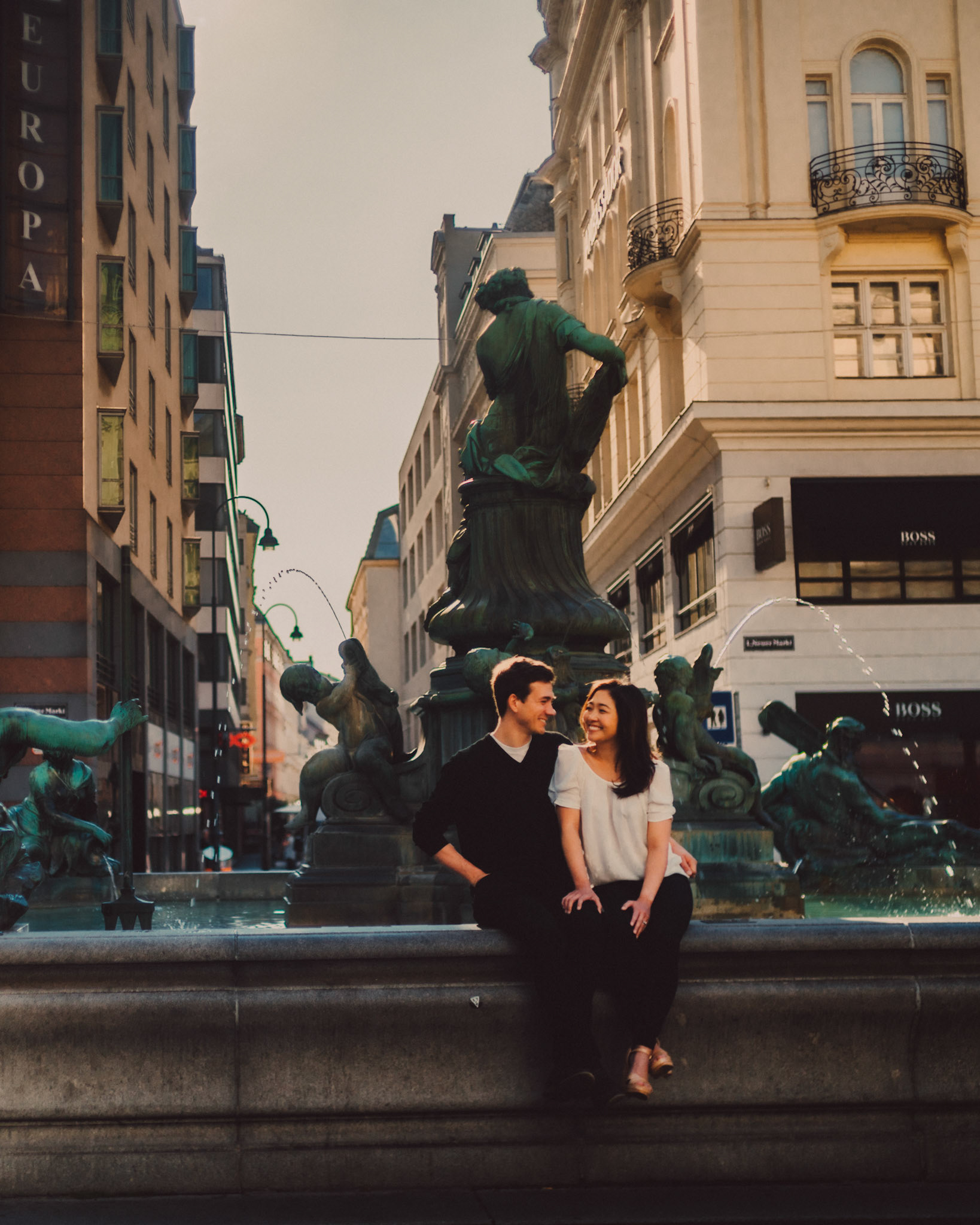 Casual and filmic destination engagement photos inspired by "Before Sunrise" movie locations, Donnerbrunnen fountain at Neuer Markt Square, Innere Stadt, Vienna, Austria, August 2017, Sony A7RII.