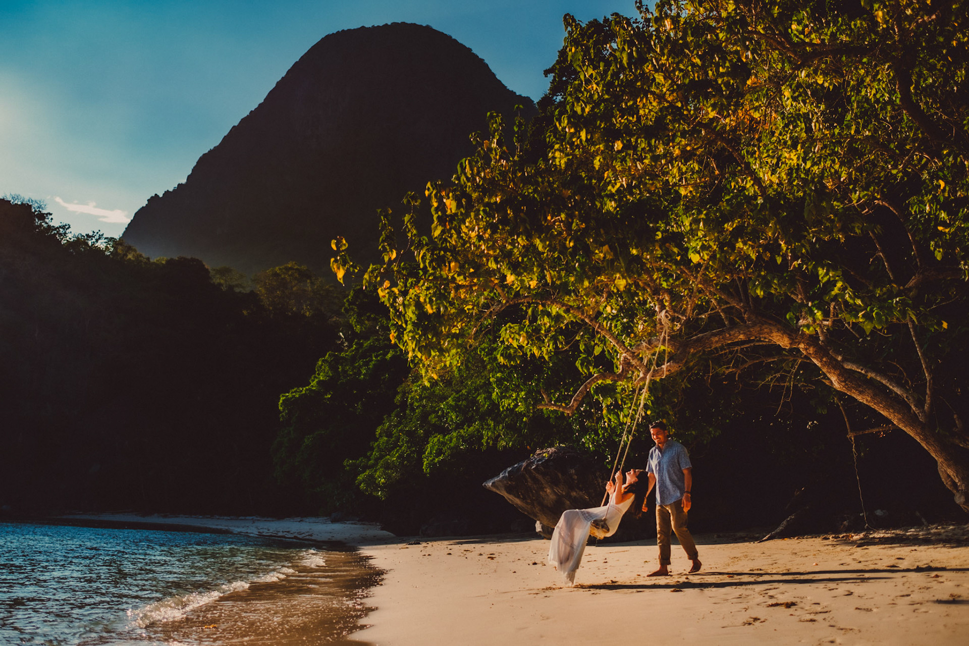Candid couple portraits on a swing in Paradise Beach, Cadlao Island, from Peter &amp; Alexis' adventure pre wedding photo shoot in El Nido, Palawan, Philippines, Southeast Asia, April 2018, Fuji XH1