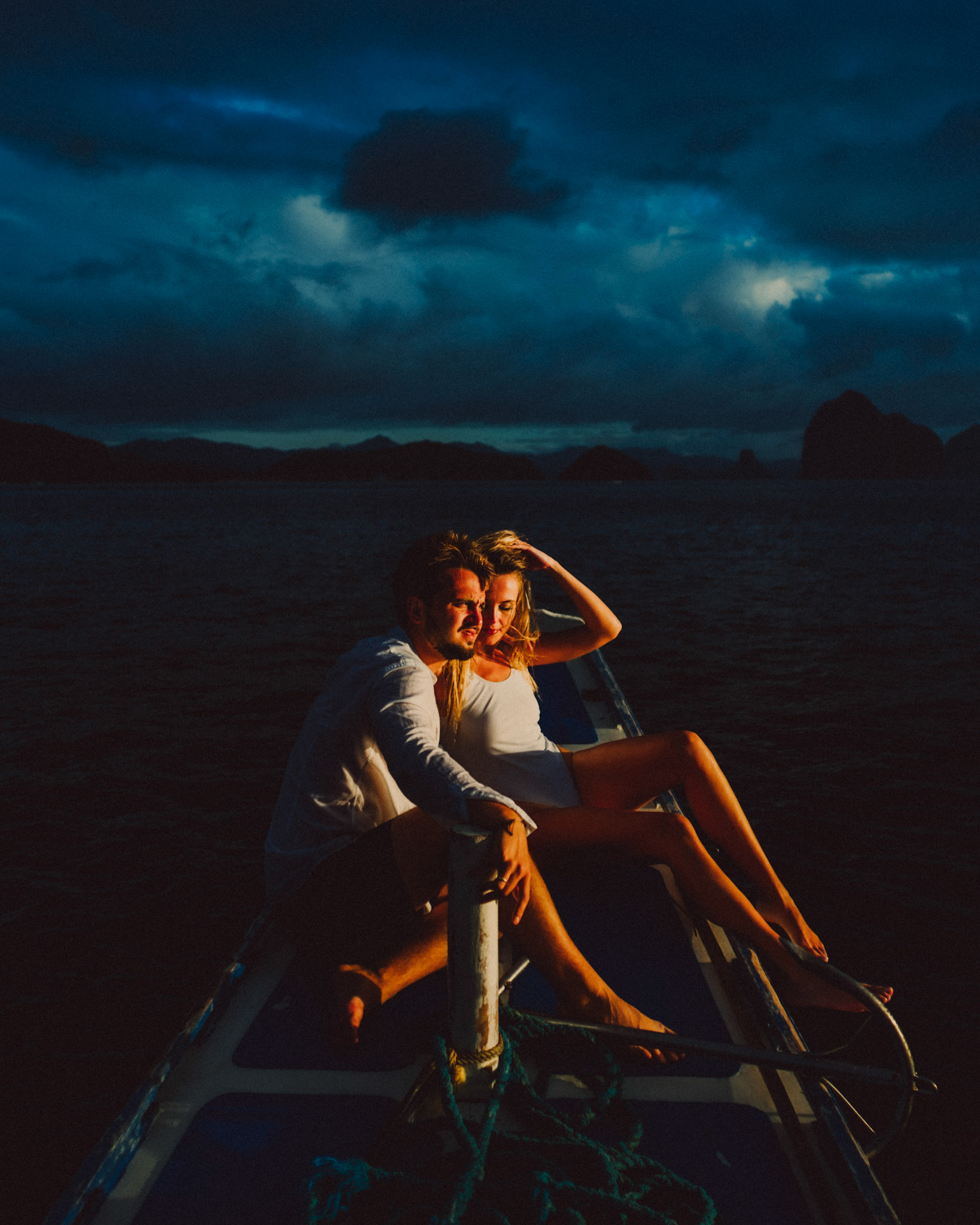 Moody golden hour island hopping adventure couple portraits against a gloomy sky, El Nido, Palawan, Philippines, Southeast Asia, December 2019, Sony A7III.