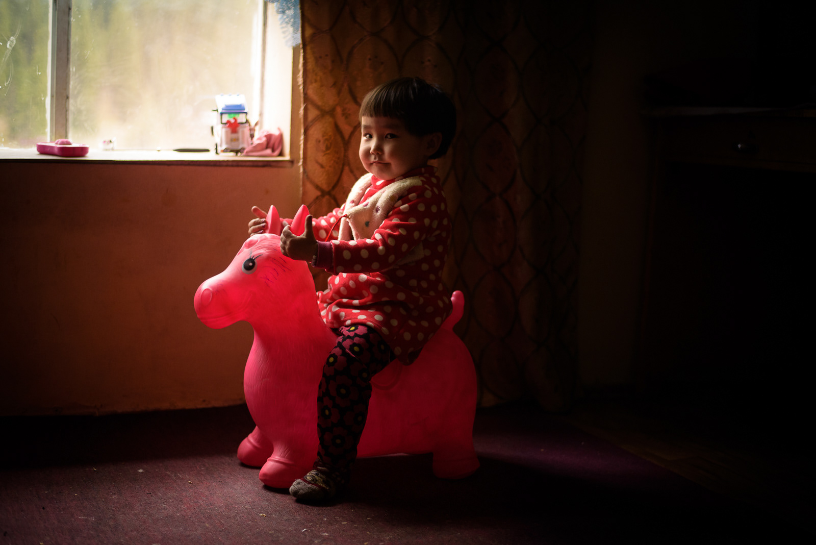 Chong, 16 h 41 – Les jouets en plastique accompagnent, impassibles, les après-midis de Nazik. Seule son imagination vient rompre la lente routine du printemps. Elle ne se doute pas encore de la radicale métamorphose de la verdure en étendue blanche.