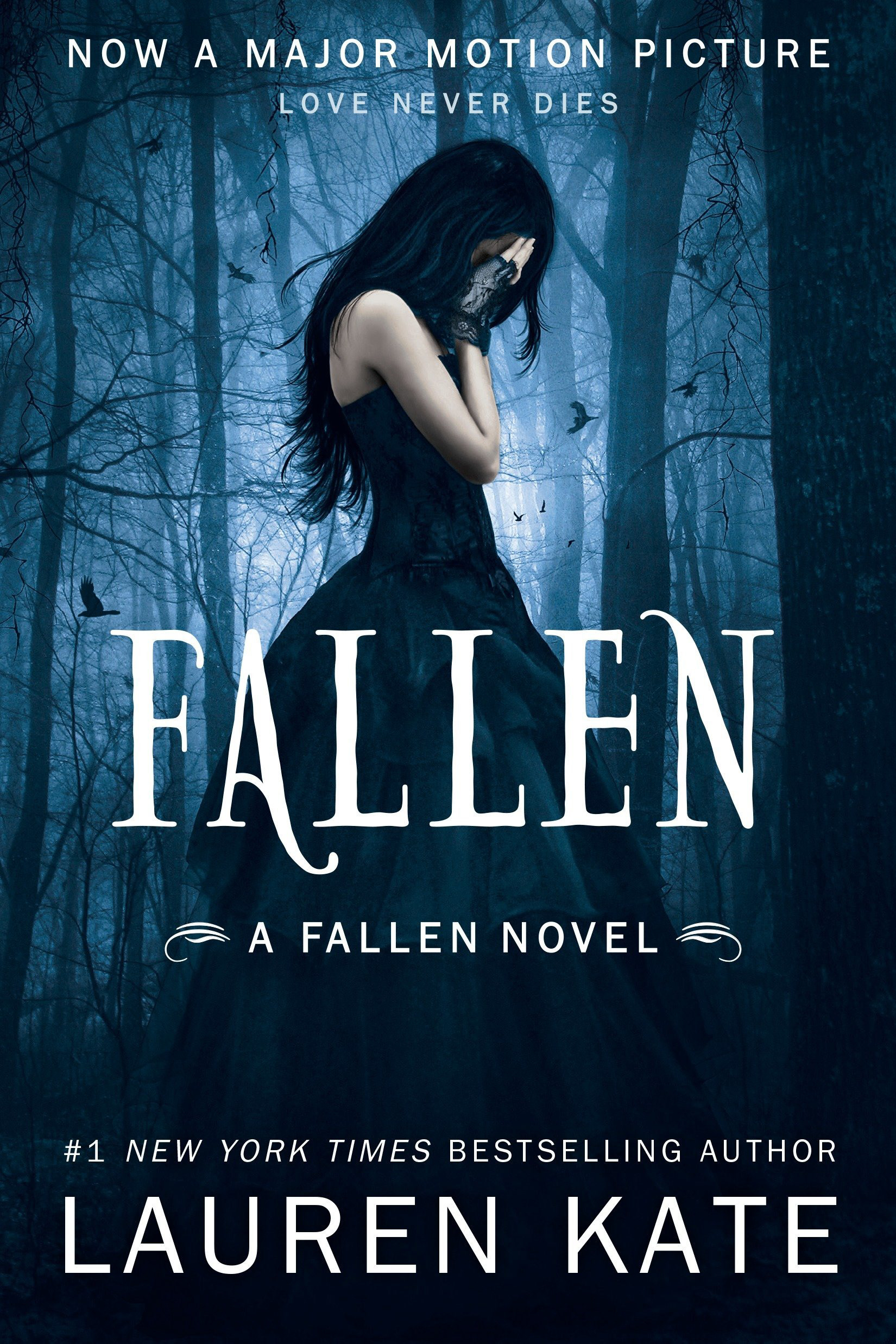 Book cover: A girl with dark hair is standing in a black dress covering her face. She's in a blue, eerie forest.