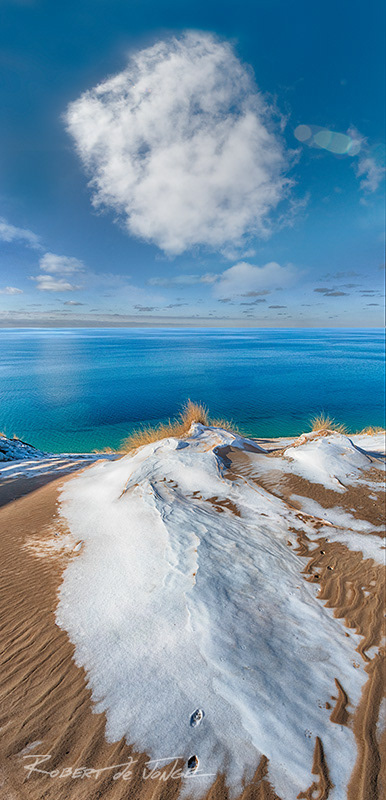 A large cloud hangs in the sky at the Lake Michigan Overlook on the Pierce Stocking Scenic Drive