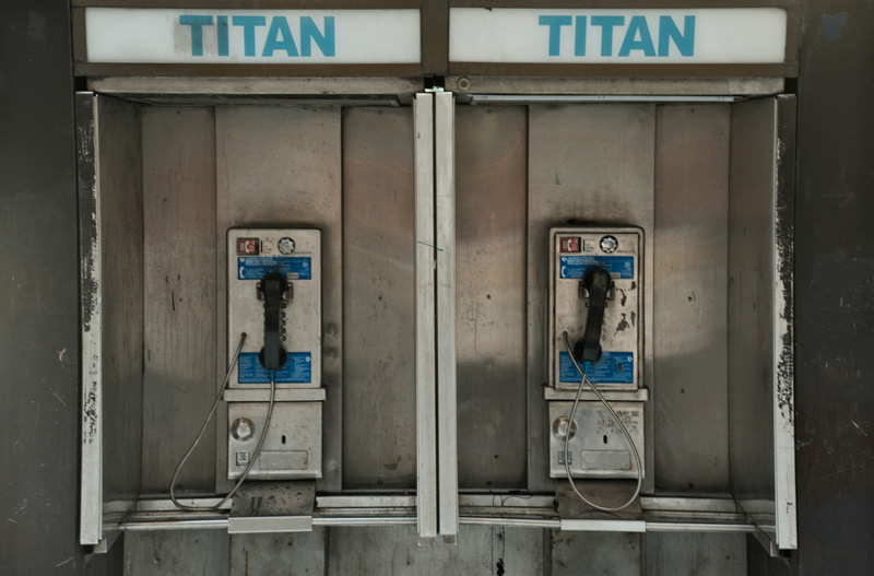 New York City public telephone to illustrate the contact form of how to get in contact with Rafael. It says the word Titan on the top, very dirty telephones.