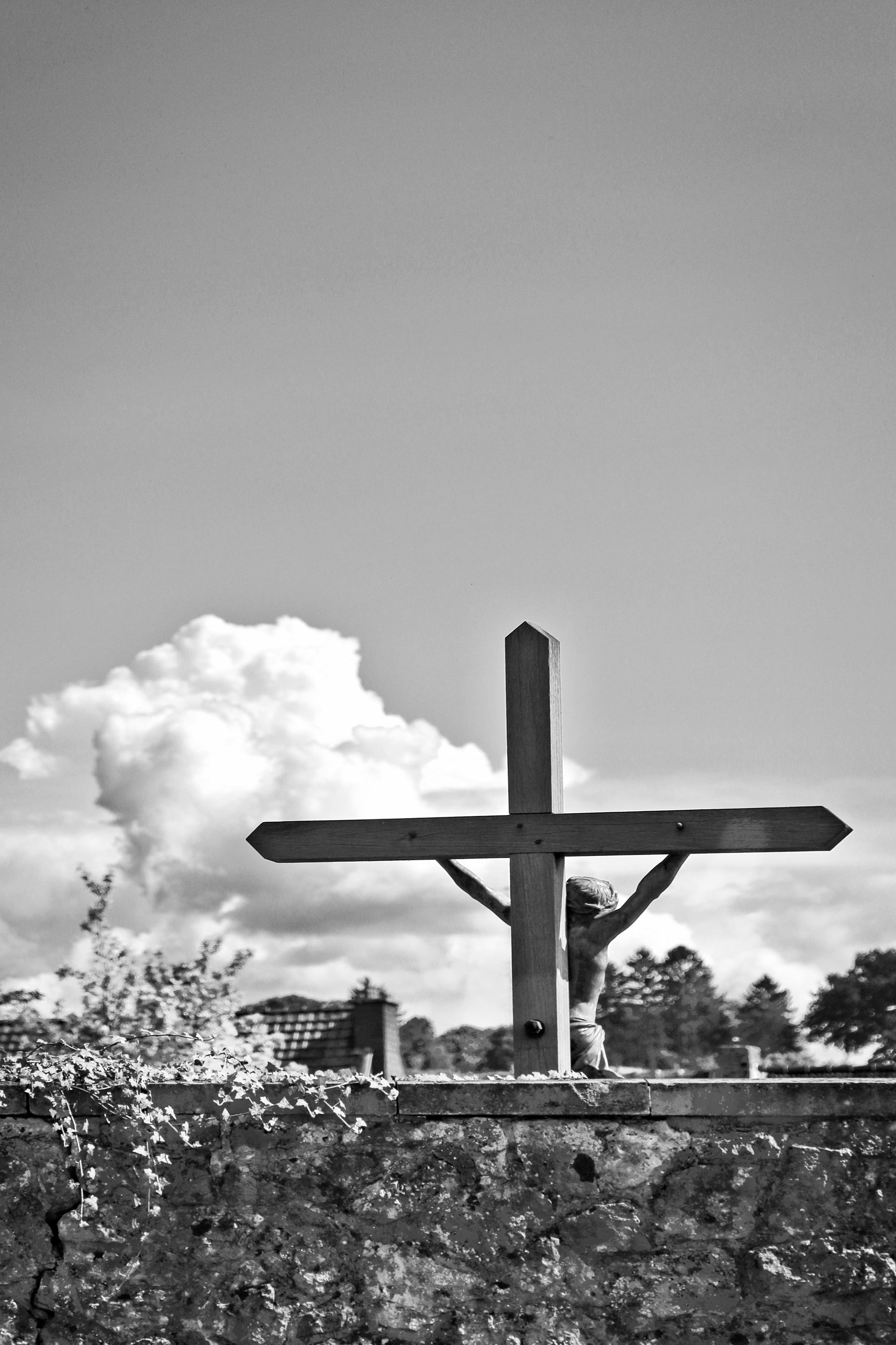 Hidden Graveyard by a wall, only a big crucifix is showing
