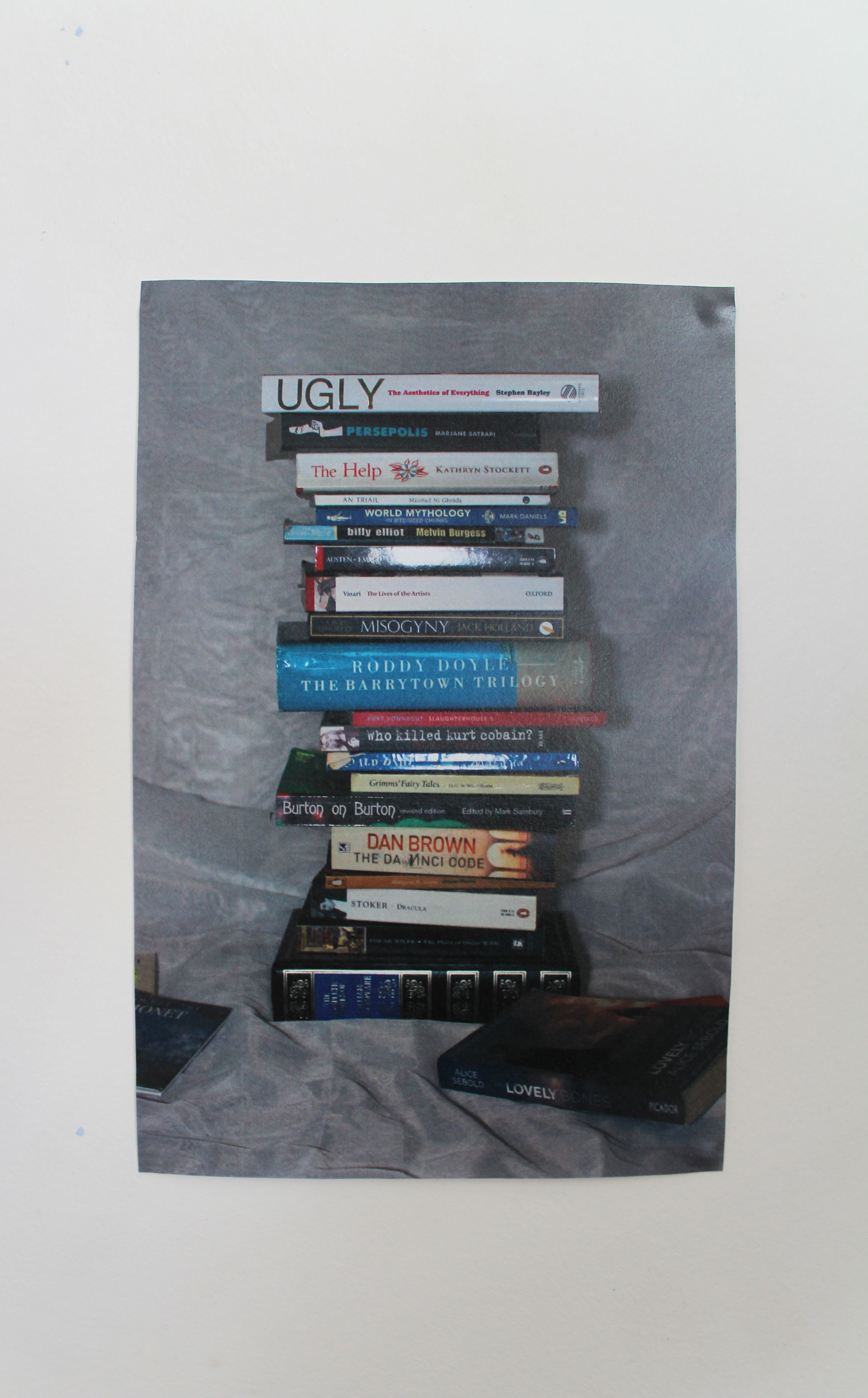 A stack of books to again the loss of the physical in the form of books. They are a collection of fiction and non-fiction books, on a variety of topics.