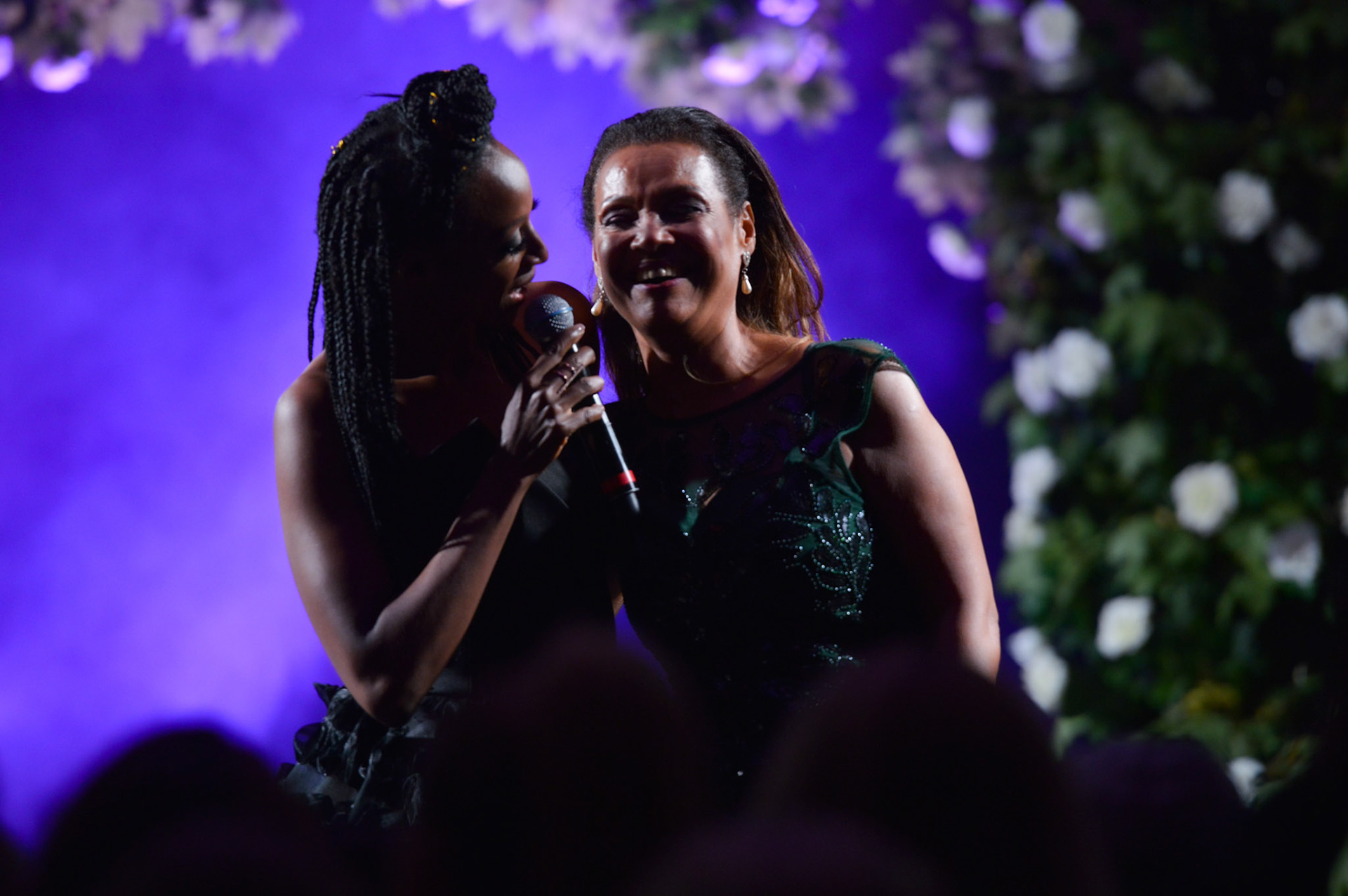 Victoria Ekanoye singing on stage at the 2019 Manchester Fashion Festival - Runway Photographer