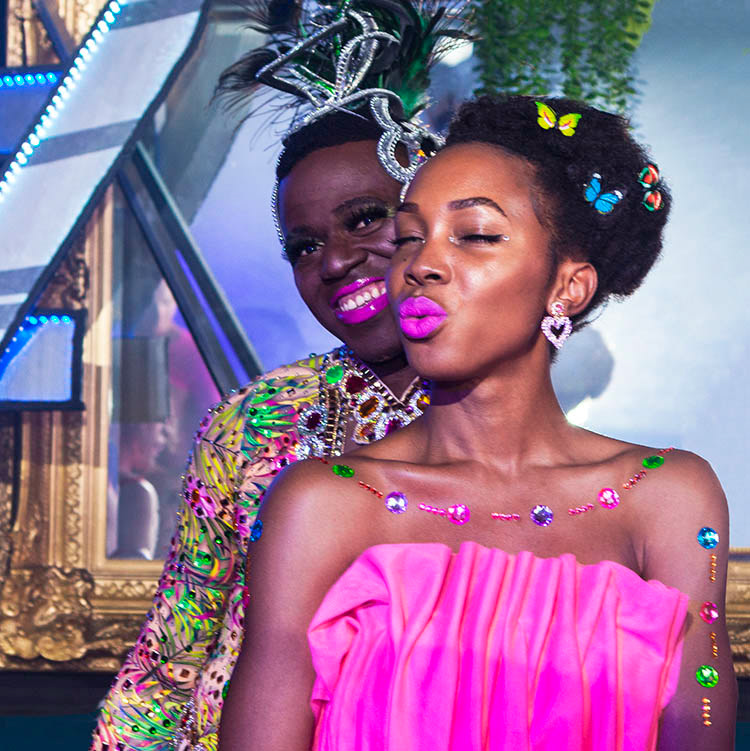 Two cast members of the Colours of Our Community float together during pre-parade celebrations, held at Universal Bar, prior to the 2021 Sydney Mardi Gras Parade.
