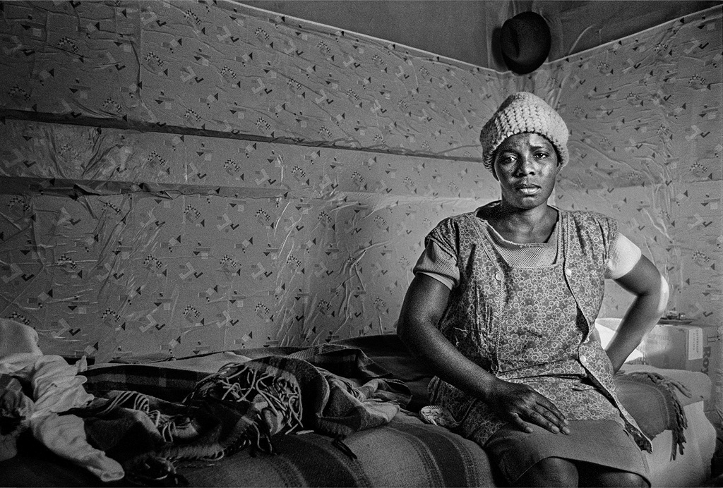 Woman in her shanty at Crossroads. Black families faced the constant threat of eviction and demolition of their homes for living as family units near cities
