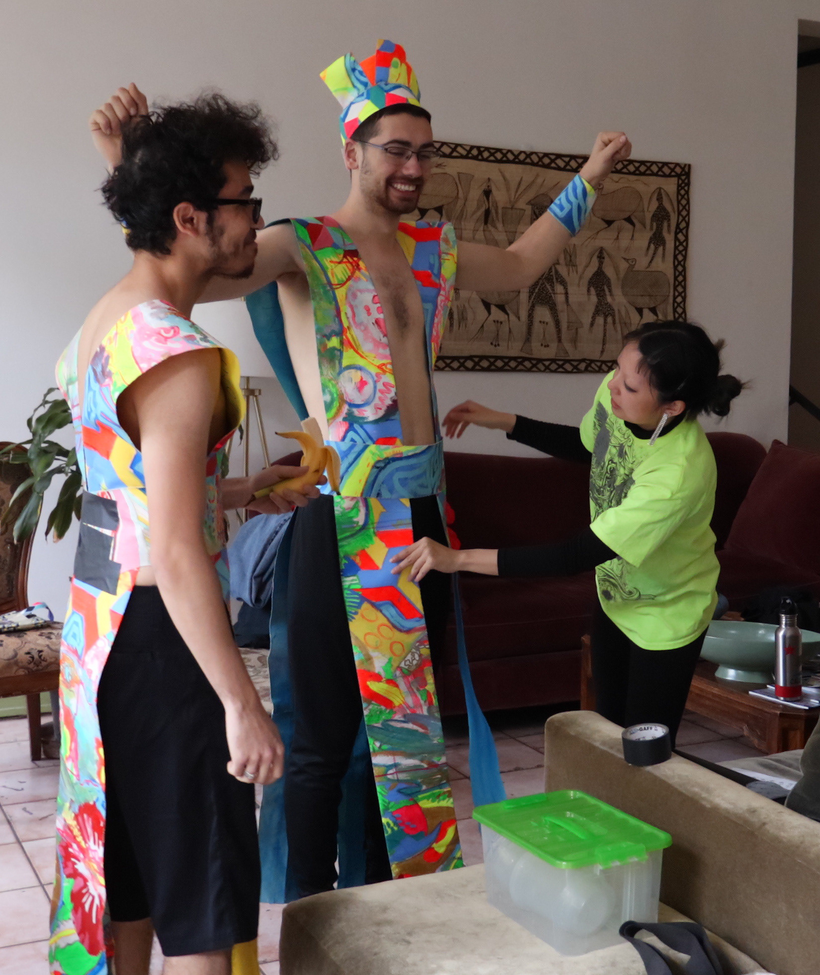 Amy fits drummers Kevin and Solomon into their costumes.
