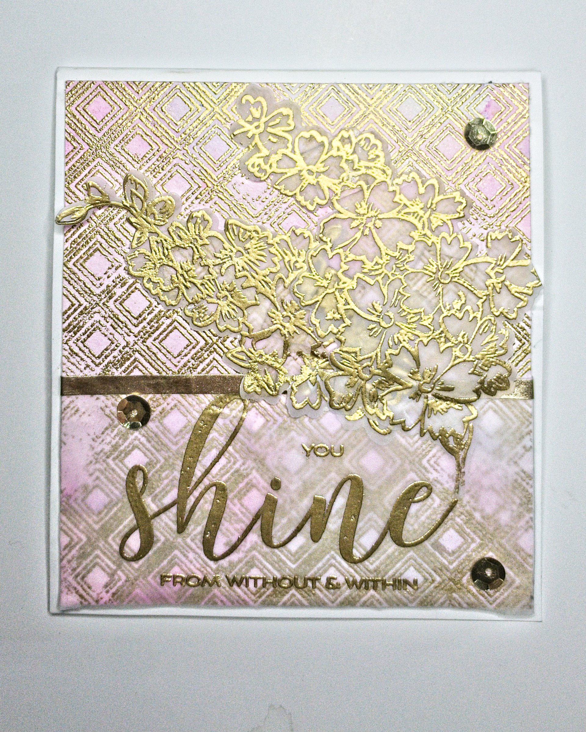 Background stamp with Heat Embossing in Gold as is the sentiment and the flowers. The latter is embossed on Vellum.