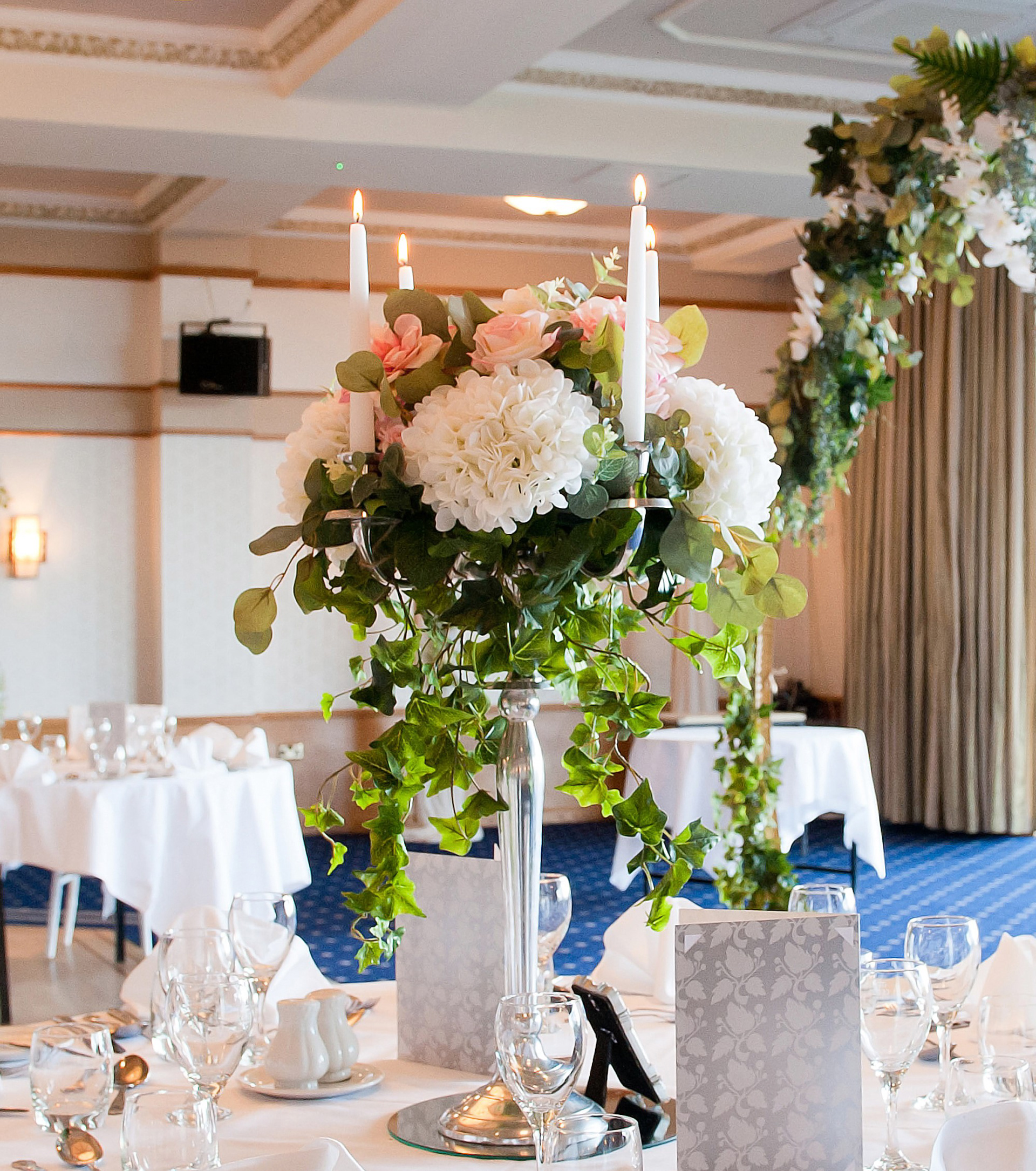 Candelabra centerpiece with garden florals & cascading foliages