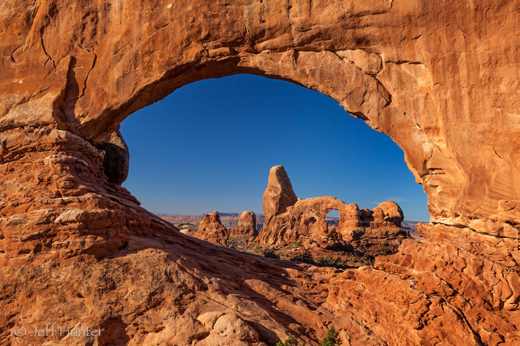 A rocky arch viewed through another rocky arch