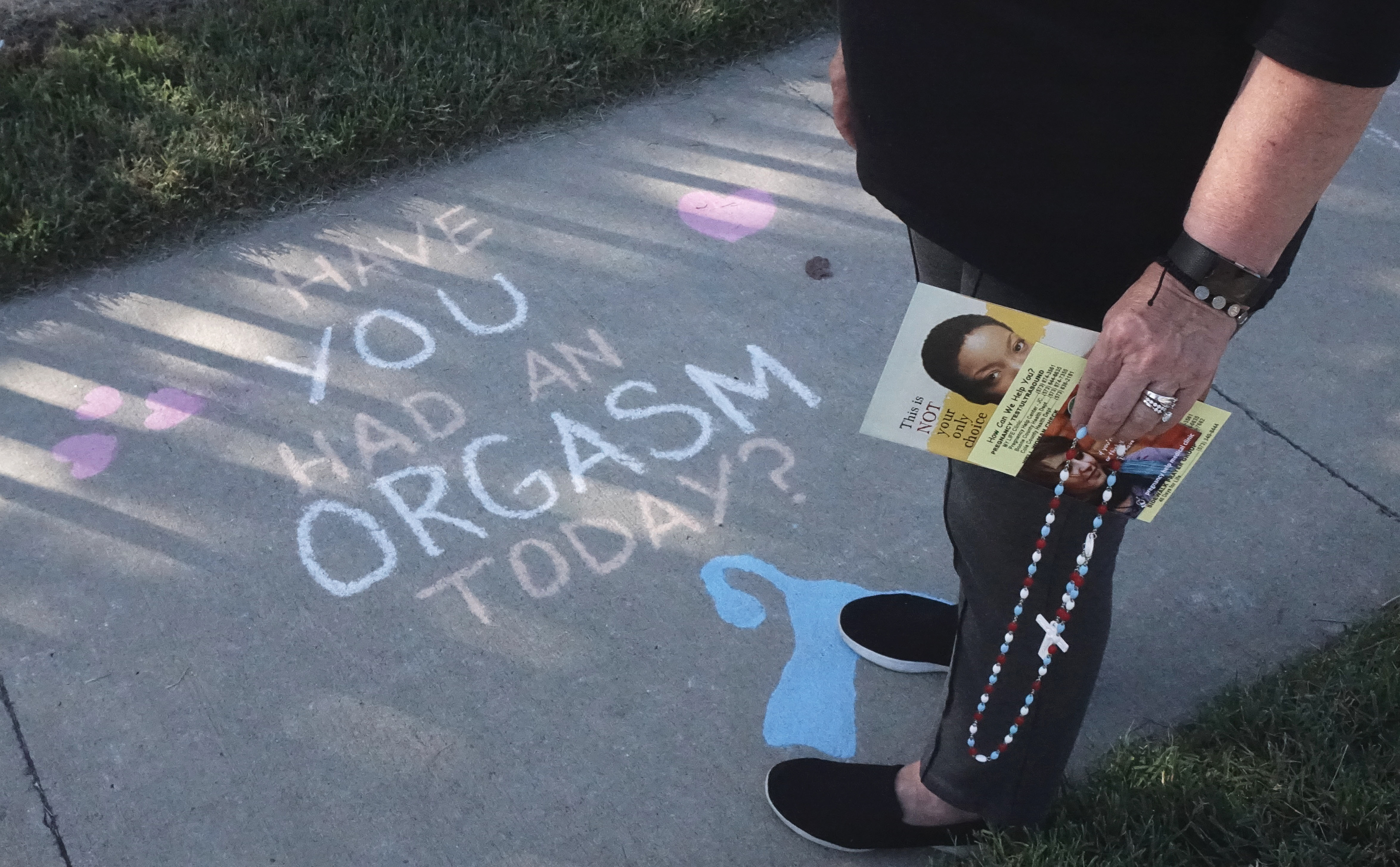 Kathy Forck, one of the leaders of Columbia’s 40 Days for Life, looks down at some chalking the Guild of Silly Heathens drew on the sidewalk in front of Planned Parenthood in Columbia, Mo., on Wednesday, Sept. 25, 2019. “We started coming here on the day that they did abortions… we were able to speak to a few people, but for the most part it was silent prayer,” Forck said. The group started doing this in February of 2009, and Forck says they started participating in 40 Days for Life in September of 2009.