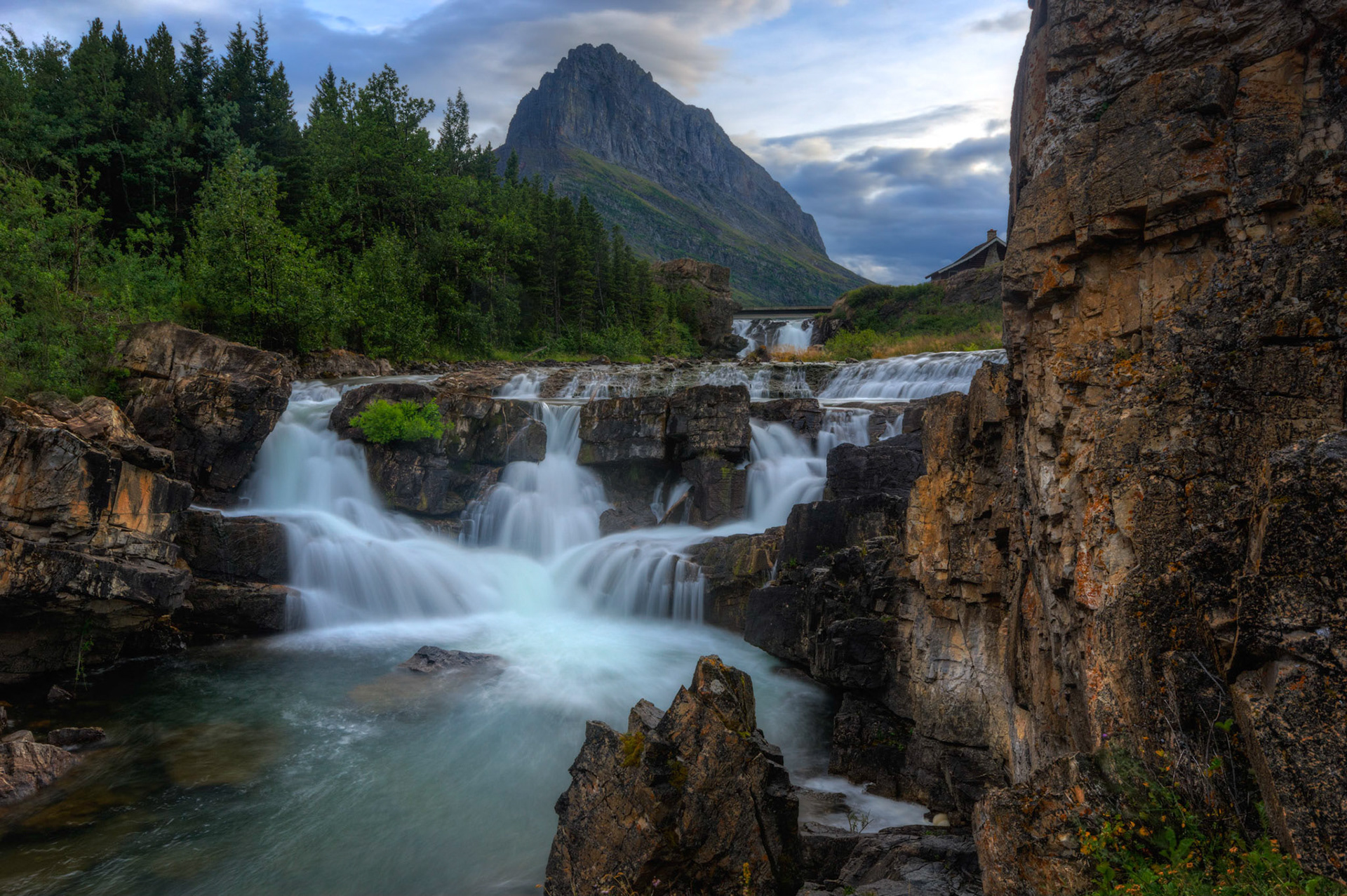 Swiftcurrent Falls and Grinnell Point, near the Many Glacier Lodge.Glacier National ParkJuly 27, 2015This is an HDR image consisting of 5 exposures merged in Photomatix Pro. Additional processing in Lightroom and Photoshop.PENTAX K-3, Sigma 10-20mm f/4-5.6 EX DCISO 100 18 mm  0.8 sec at ƒ / 11