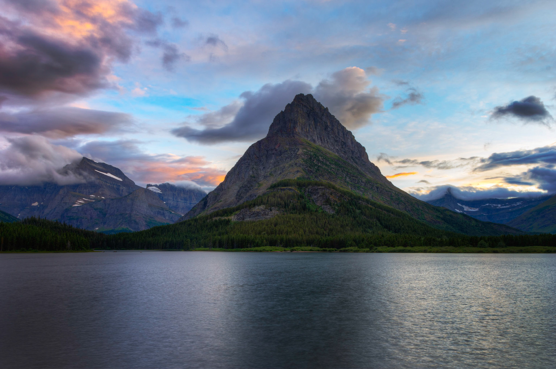 Grinnell Point and Swiftcurrent Lake at sunset.Glacier National ParkJuly 27, 2015This is an HDR image consisting of 5 exposures merged in Photomatix Pro. Additional processing in Lightroom and Photoshop.PENTAX K-3, Sigma 18-250mm f/3.5-6.3 DC OS HSMISO 100 18 mm  0.8 sec at ƒ / 11
