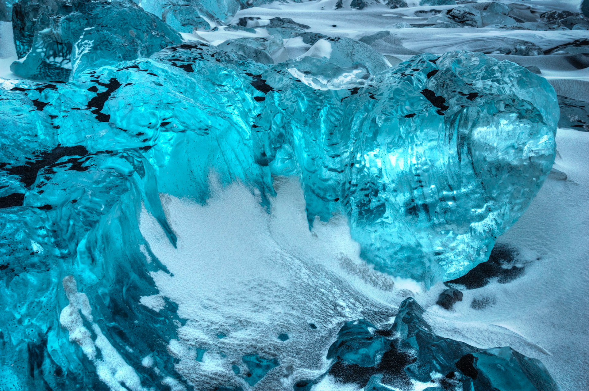 Blue ice, black sand, and white snow.  Black sand beach near Jökulsárlón.VatnajökulsþjóðgarðurAusturland, IcelandFebruary 1, 2016This is an HDR image consisting of 5 exposures merged in Photomatix Pro. Additional processing in Lightroom and Photoshop.PENTAX K-3, SIGMA 18-35mm F1.8 DC HSM A013ISO 200 23 mm  3.0 sec at ƒ / 5.6