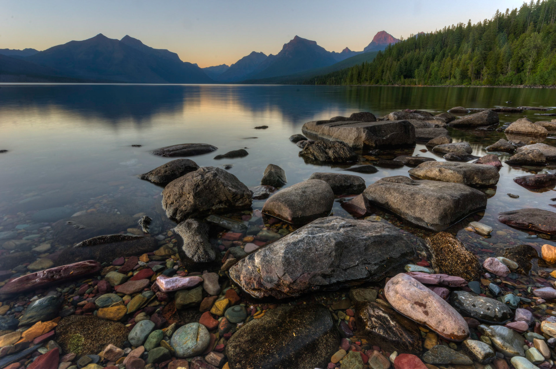 Sunset along the shore of Lake McDonald.Glacier National ParkJuly 30, 2015This is an HDR image consisting of 5 exposures merged in Photomatix Pro. Additional processing in Lightroom and Photoshop.PENTAX K-3, Sigma 10-20mm f/4-5.6 EX DCISO 100 13 mm  4.0 sec at ƒ / 22