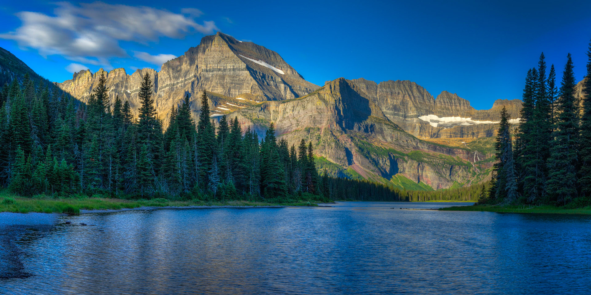 Mt. Gould and Angel Wing above the outlet stream of Lake Josephine.Glacier National ParkJuly 29, 2015This is an HDR panoramic image consisting of 5 frames comprised of 5 exposures each. HDR processing performed in Photomatix Pro.  Panoramic stitching performed in Photoshop. Additional processing performed in Lightroom and Photoshop.PENTAX K-3, Sigma 18-250mm f/3.5-6.3 DC OS HSMISO 100 45 mm  ¹⁄₃₀ sec at ƒ / 11