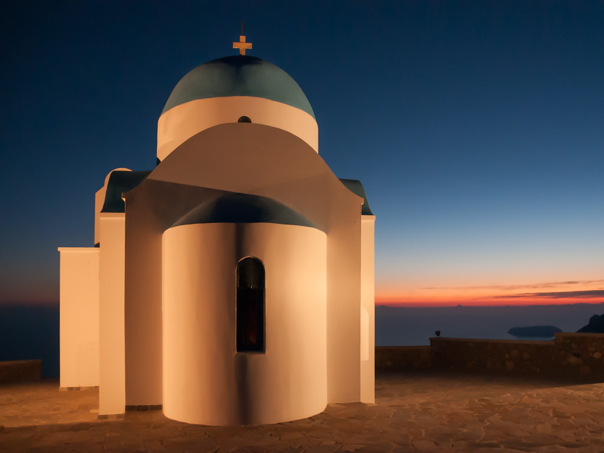 Sunset on the Island of Nisyros, Greece. The Church sits high on a mountain overlooking the sea