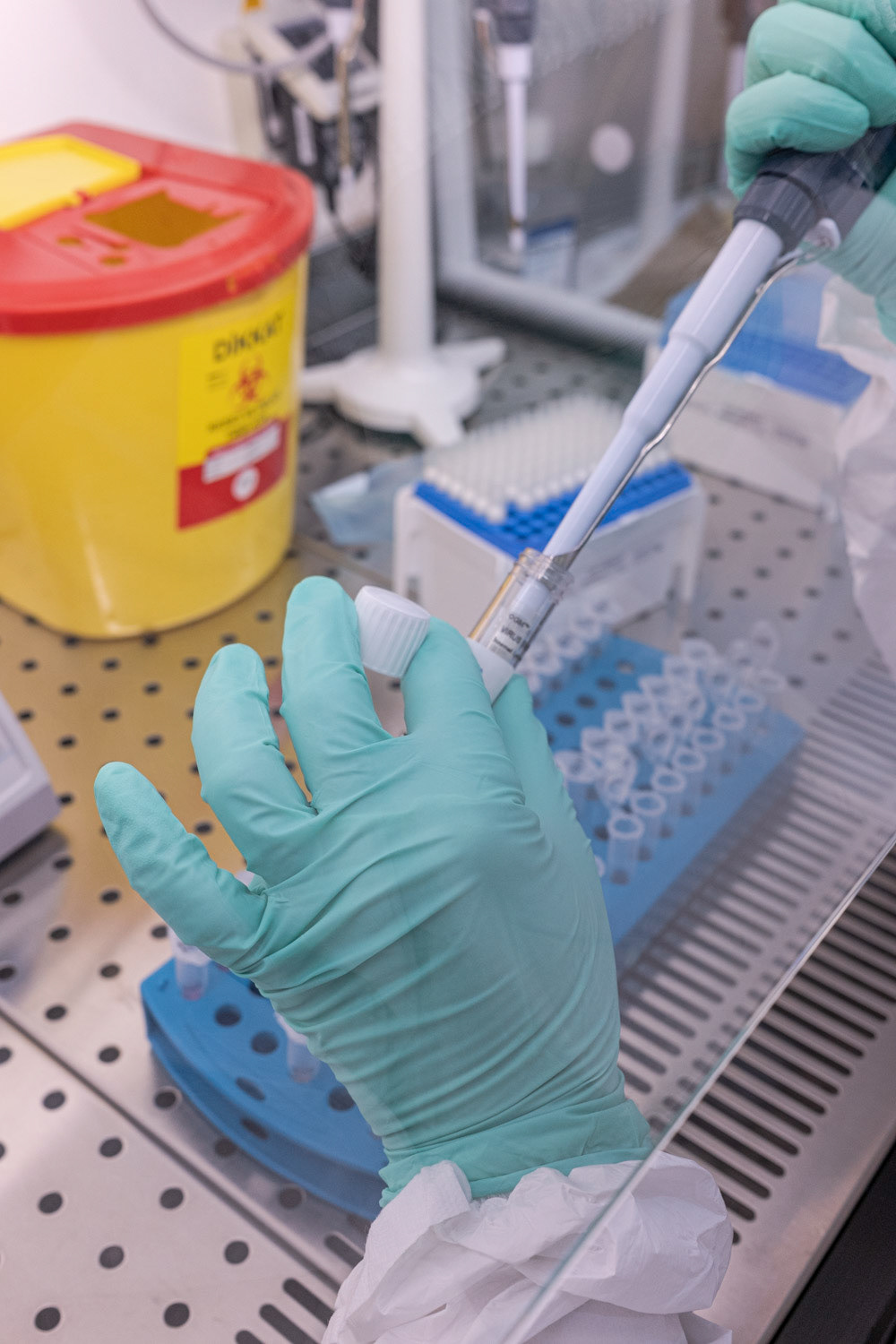 A molecular biologist wearing protective equipment as she process to extract viral RNA in a high safety laboratory chamber at a private hospital in Istanbul on 1 May 2020.