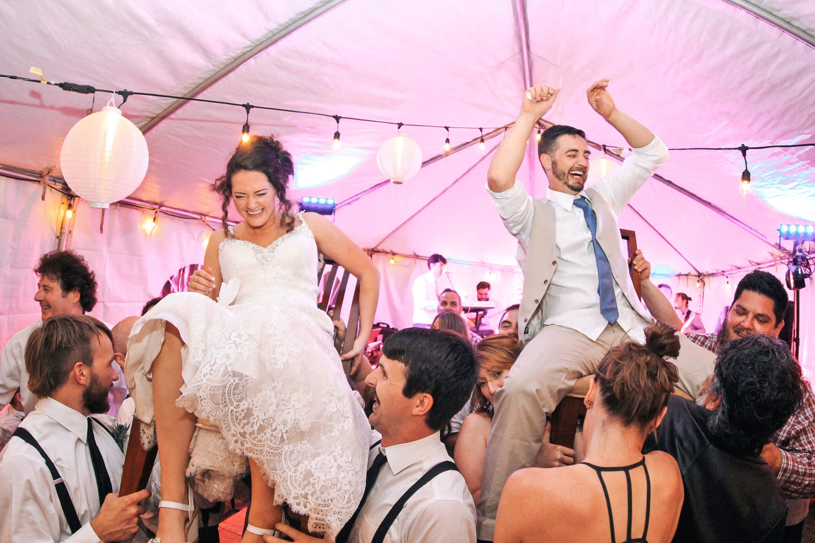 Married couple being lifted up on the dance floor for Jewish chair dance