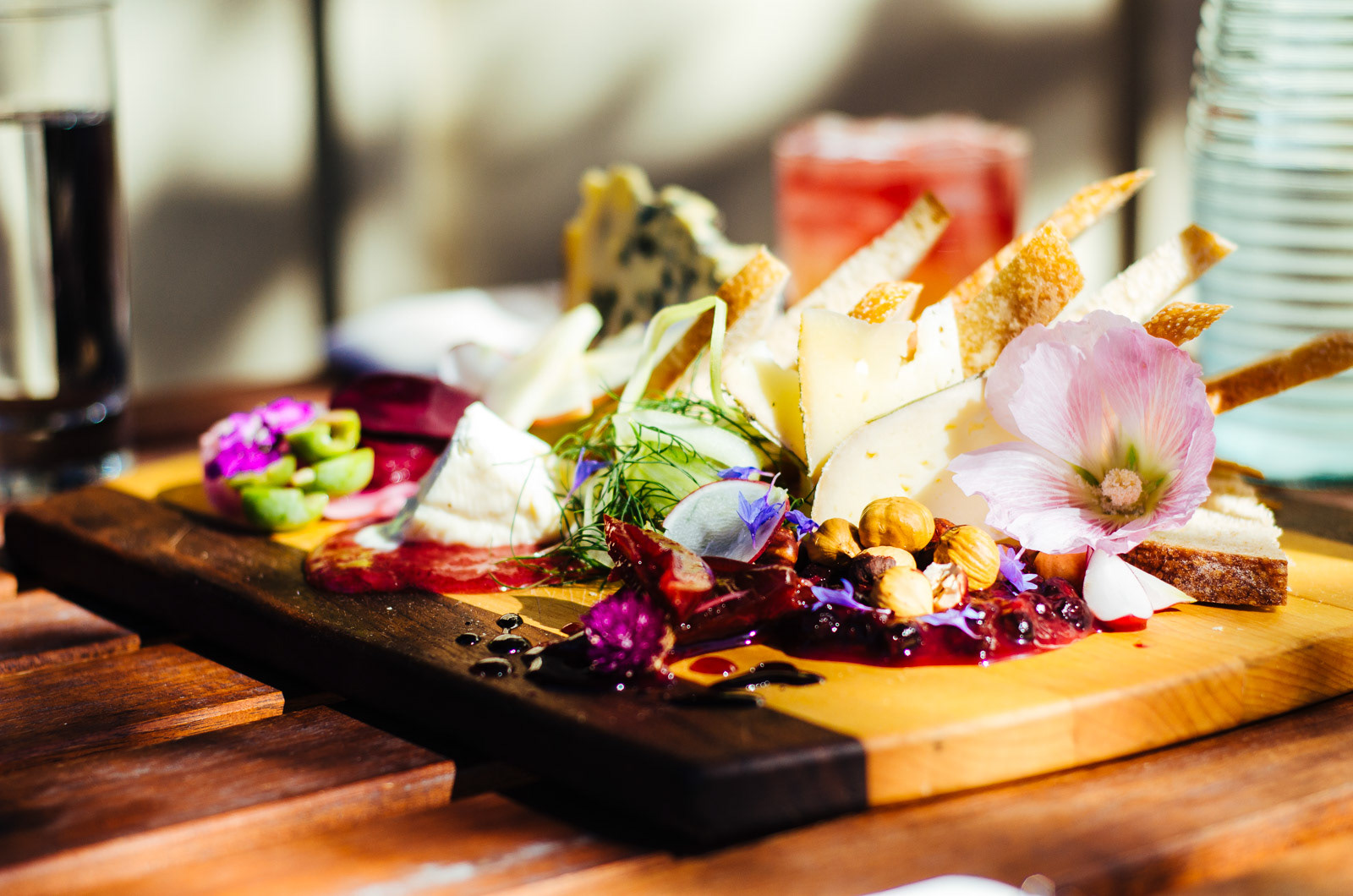 Close-up of cheese and charcuterie board on outdoor table at Grit Kitchen and Wine