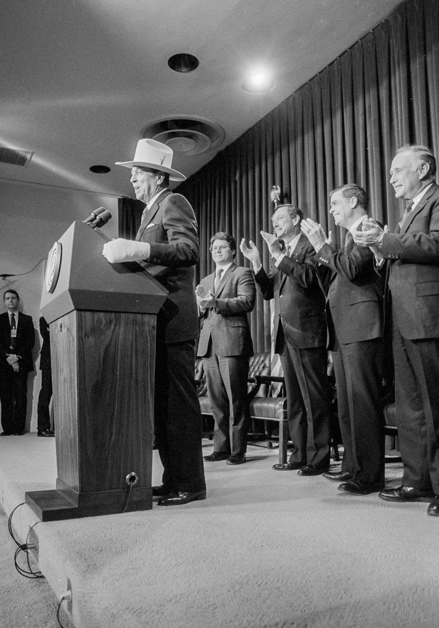 President Reagan wears a cast on his left hand from surgery and a cowboy hat, given to him by assembled business group, as he annouced his final budget subission to CongressJanuary 9, 1989.