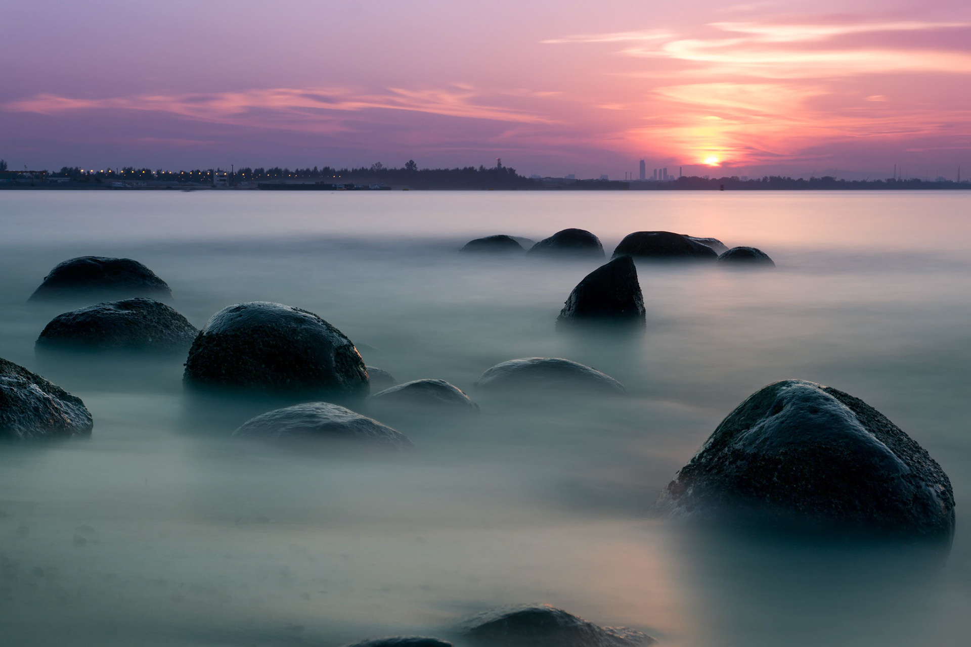 This was my second time taking photos at Punggol Point, almost exactly a year after the last time. I remember last time being extremely hot, so this time I went down for sunset instead. My camera still warned about overheating, but we both persevered to get this shot.Taken with a 10-stop ND filter, 60s at f/11, a few minutes after sunset.