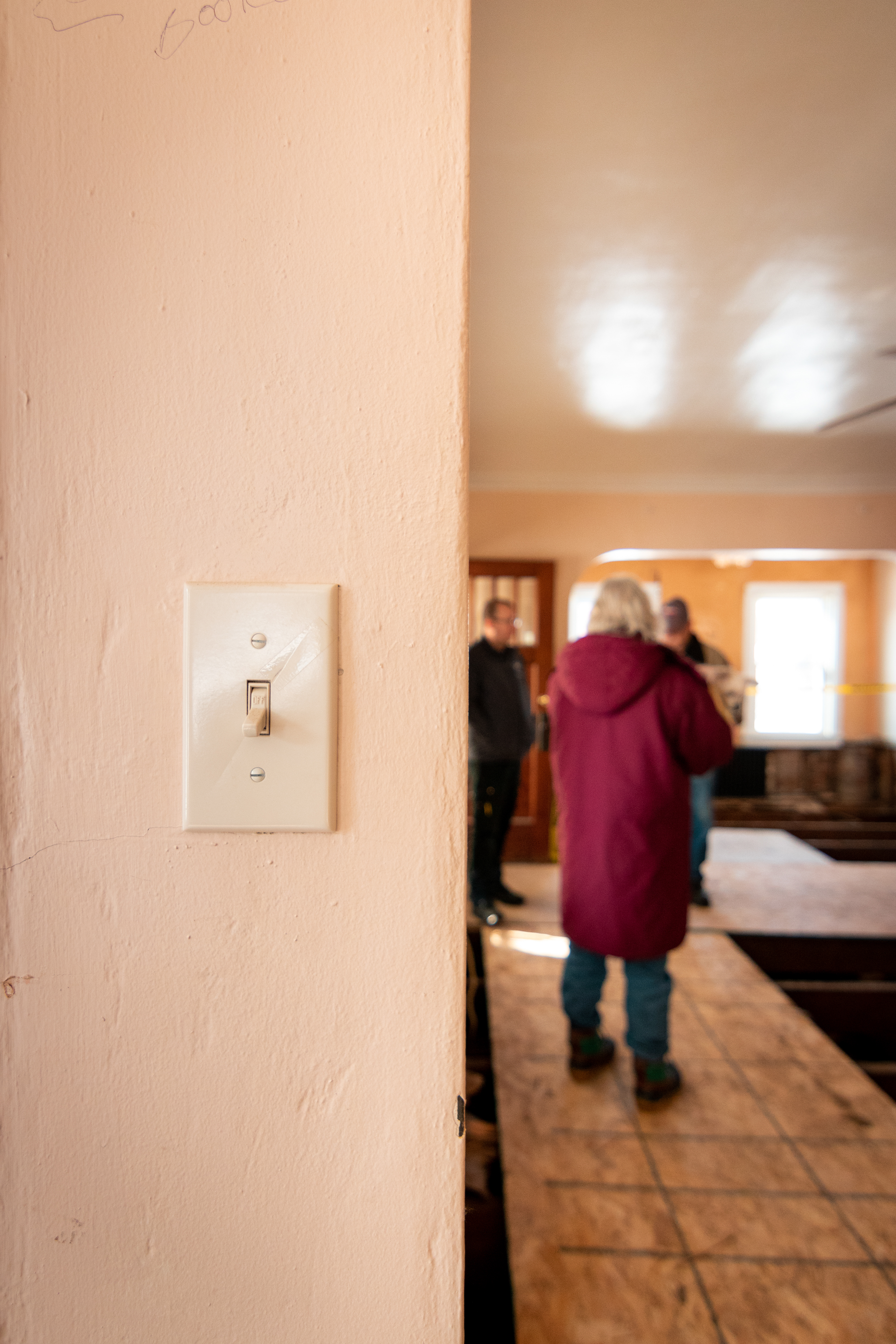 Bob Dublin and his family stand in his destroyed house trying to figure out which way to flip the switch.