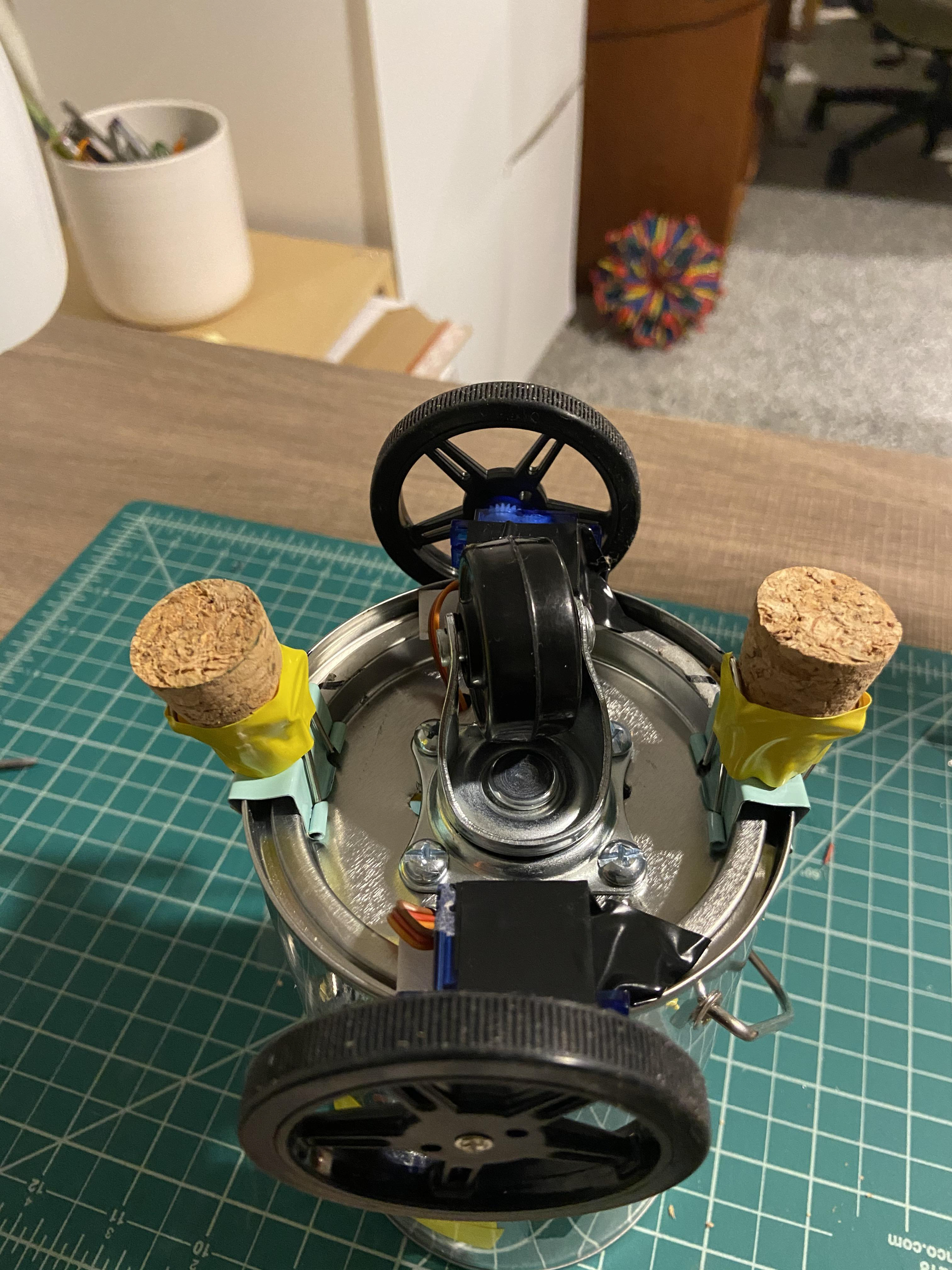 Courtesy of my mom, we stuck corks in the binder clip handles for a softer bump for the robot.