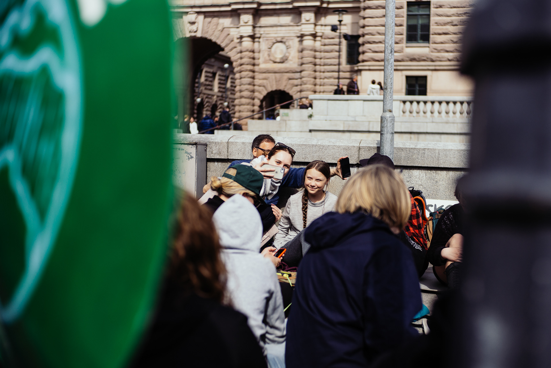 A woman takes a selfie with Greta Thunberg.