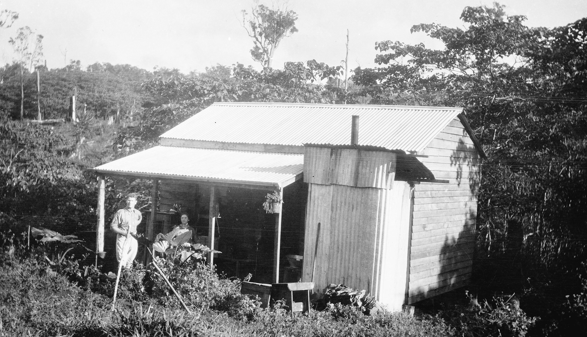 Reinholds Camp at Millaa-Millaa, Men on verandah of hut at Reinholds Camp at Millaa-Millaa. Bush in background