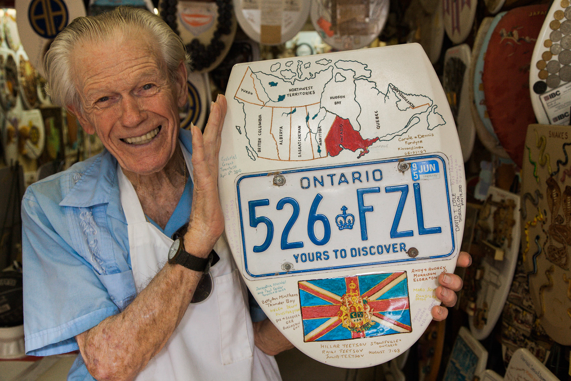 Toilet Seat Art Museum creator Barney Smith holds the Ontario license plate seat I just signed.