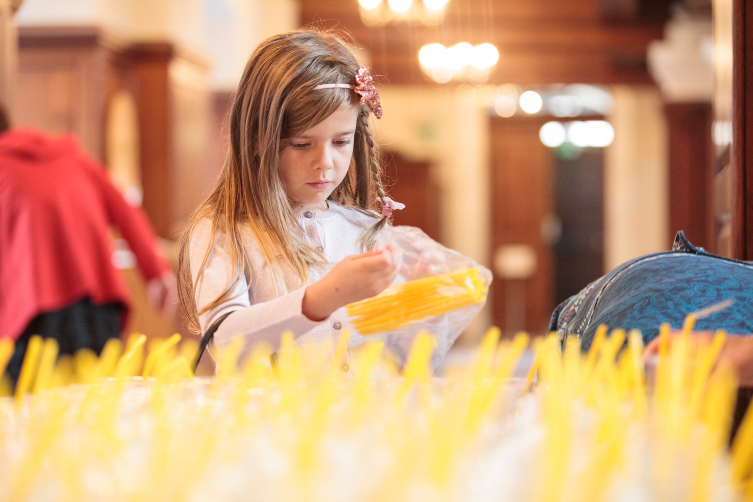 child helps set up drinks for after the ceremony