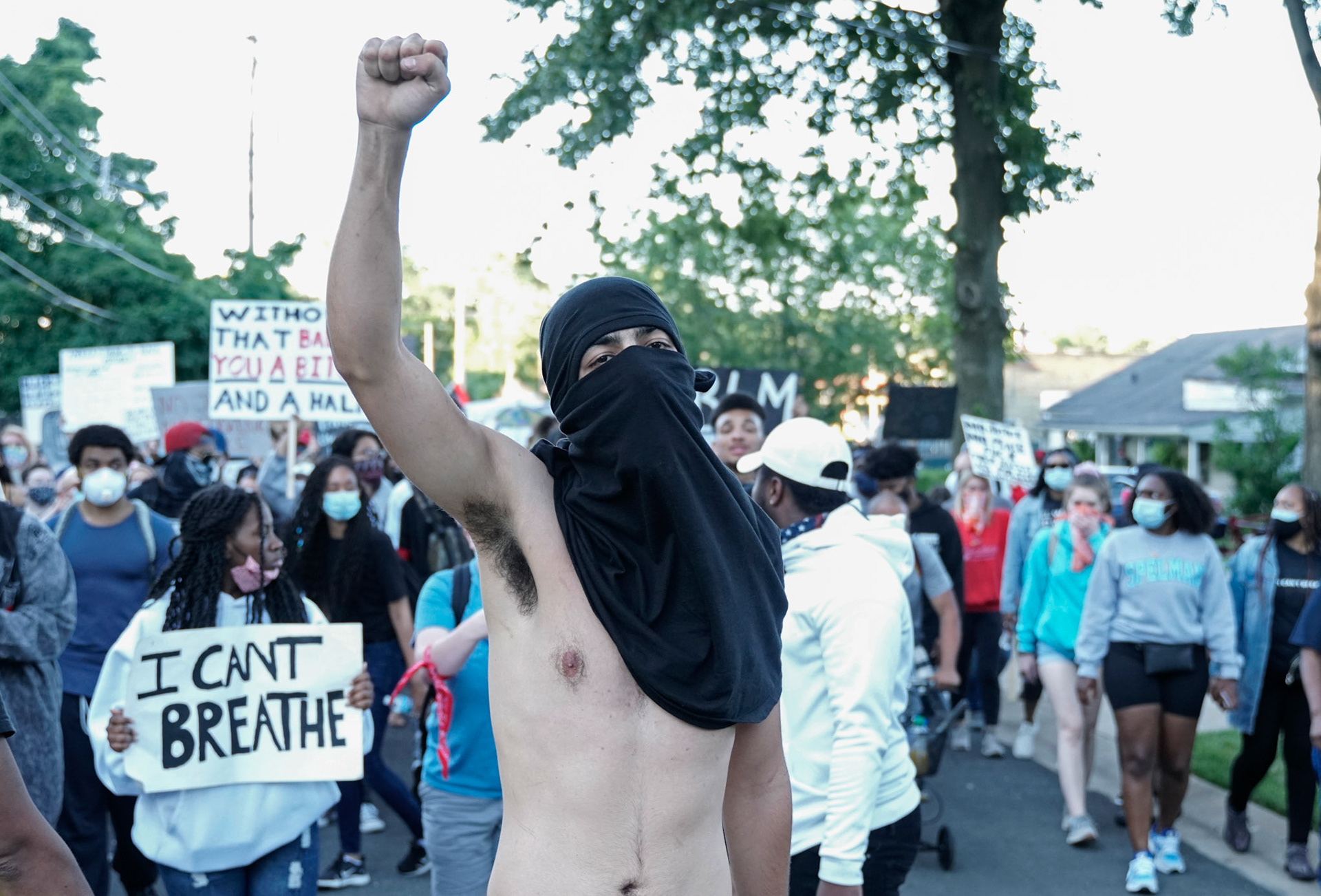 An activist holds up his fist in Florissant, Mo., during a protest on Wednesday, June 10, 2020. Protestors gathered to call for the removal of Florissant detective Joshua Smith after a video was captured of him striking an unarmed man with his car and arresting the man.