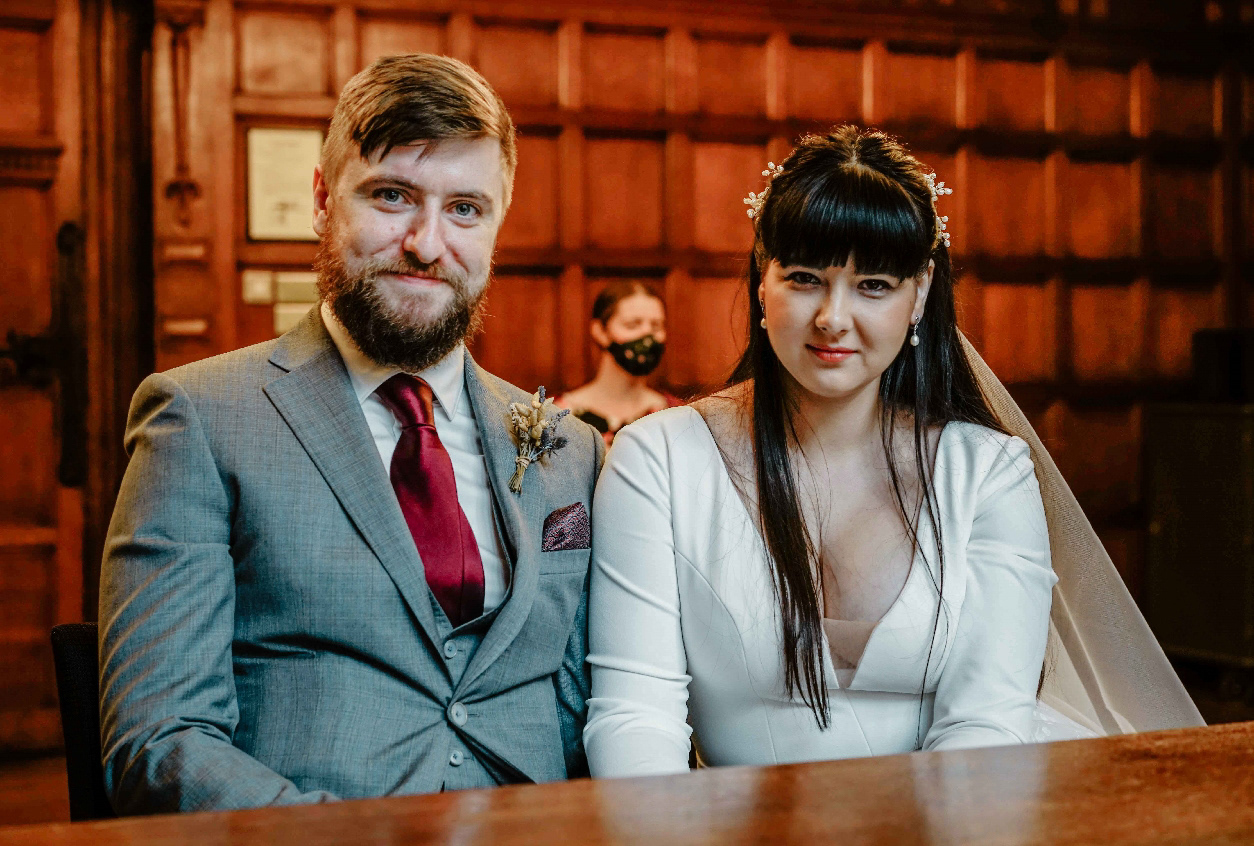 bride and groom sat at wedding altar nearly married in oxford town hall with oxfordshire photographer david lefebvre