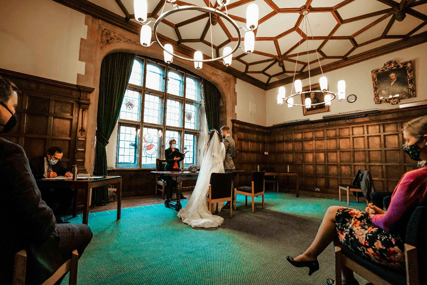 december covid wedding photograph taken inside oxford town hall with bride and groom at altar with photographer david lefebvre