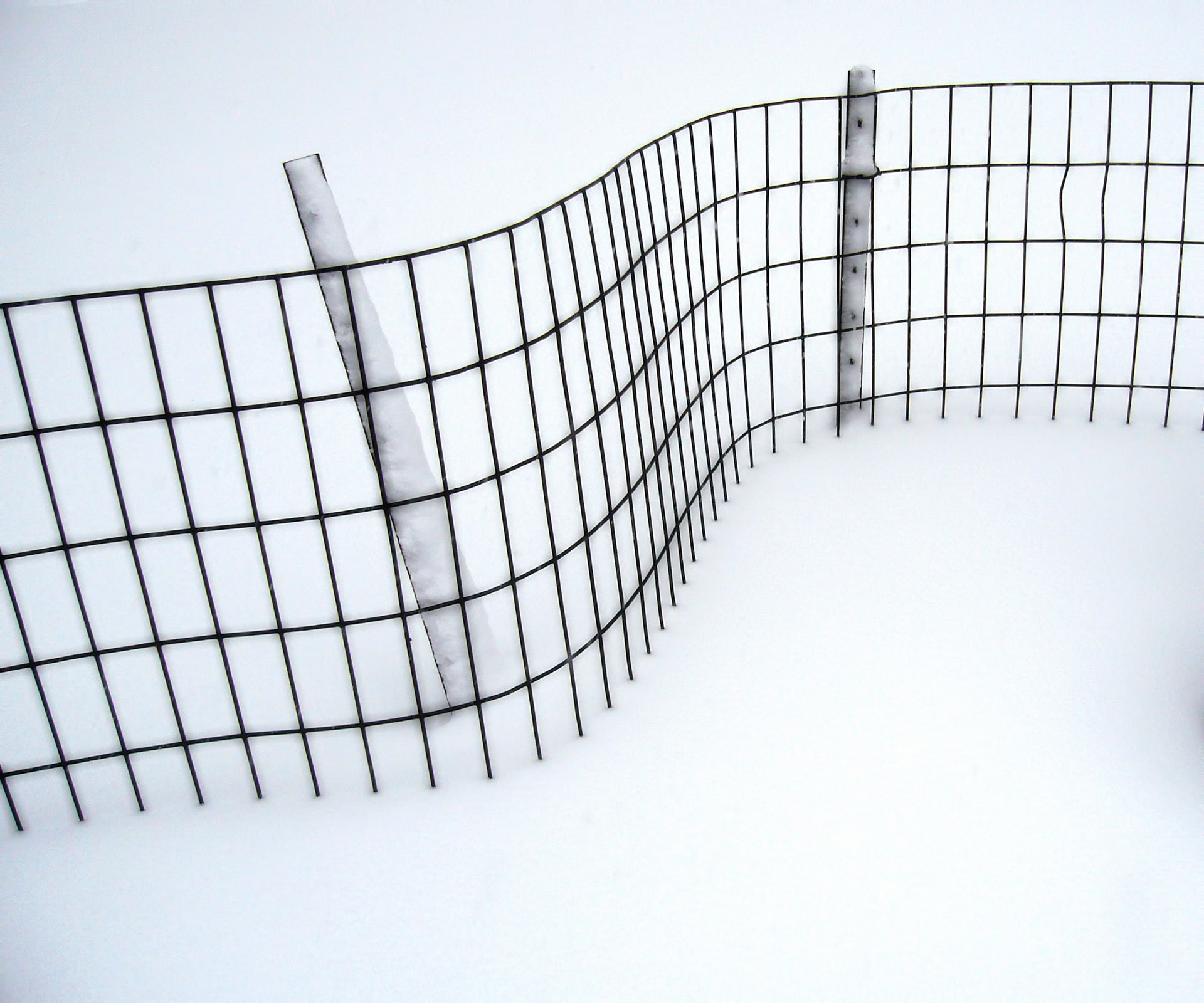 A fence in Central Park during a blizzard in NYC.