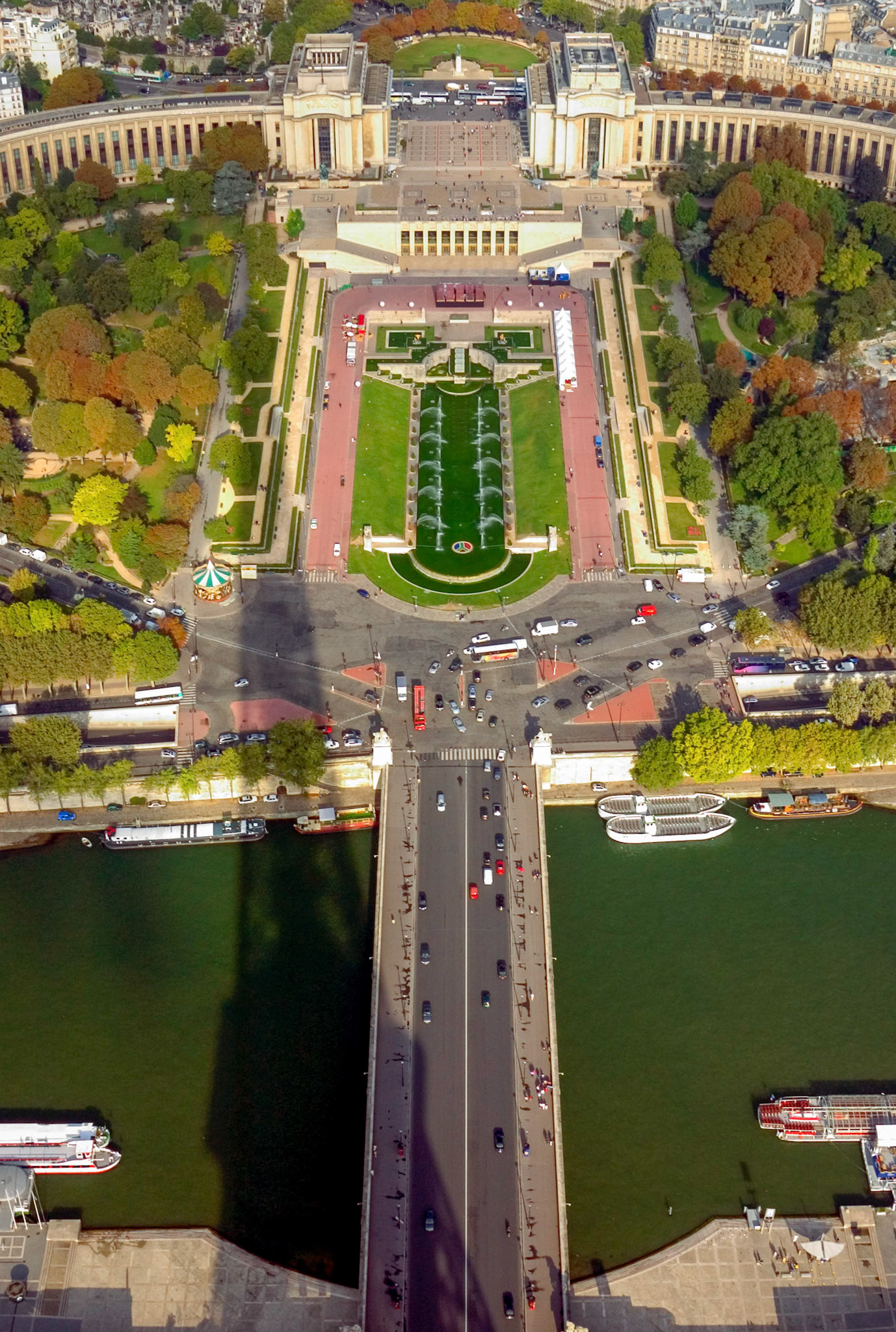 The shadow of the Eiffel Tower falling across the Seine and Trocadero Gardens as taken from the very top of the tower.