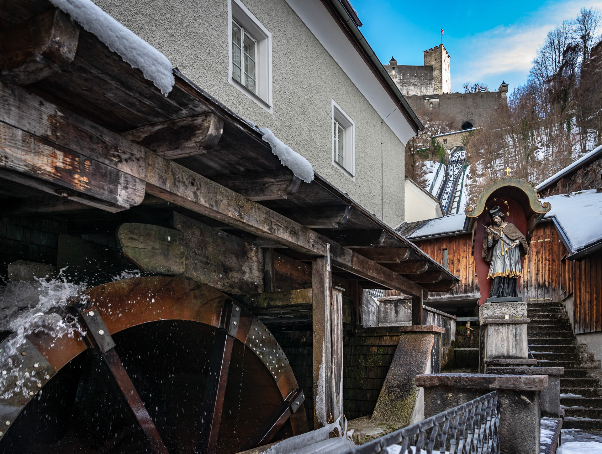 Millwheel of the bakery St. Peter (oldest bread bakery of Salzburg), above: castle Hohensalzburg